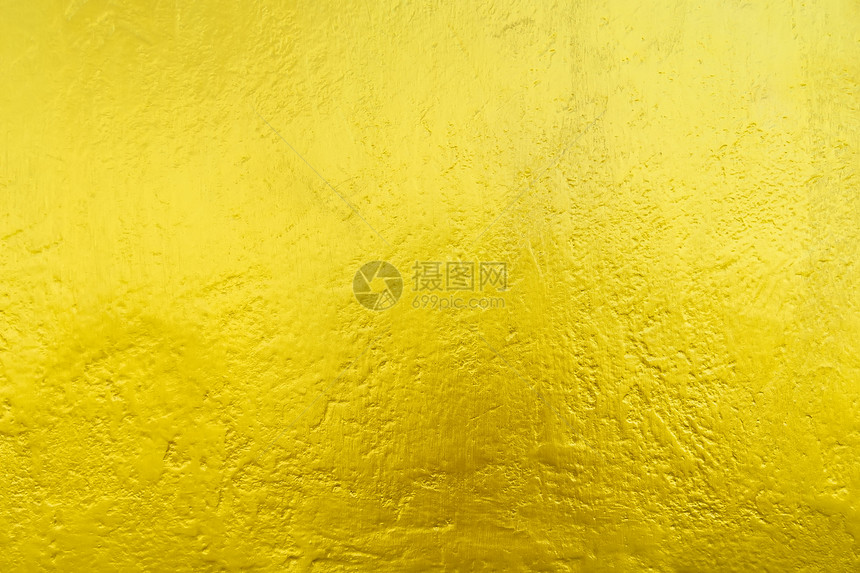 从金色的墙壁纹理和阳光的抽象背景奢侈和优雅的墙纸图片