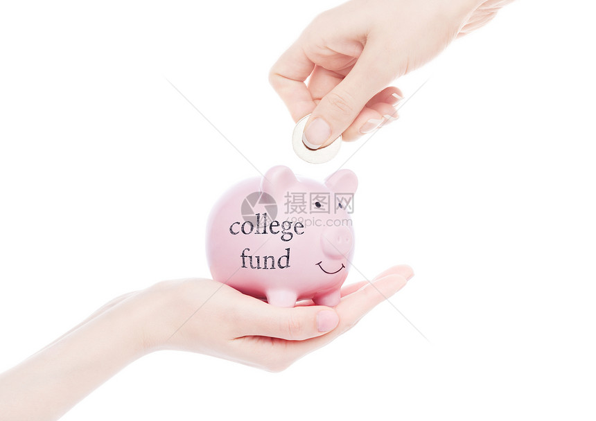 女手握着有大学基金概念的猪银行将硬币放入白色背景图片