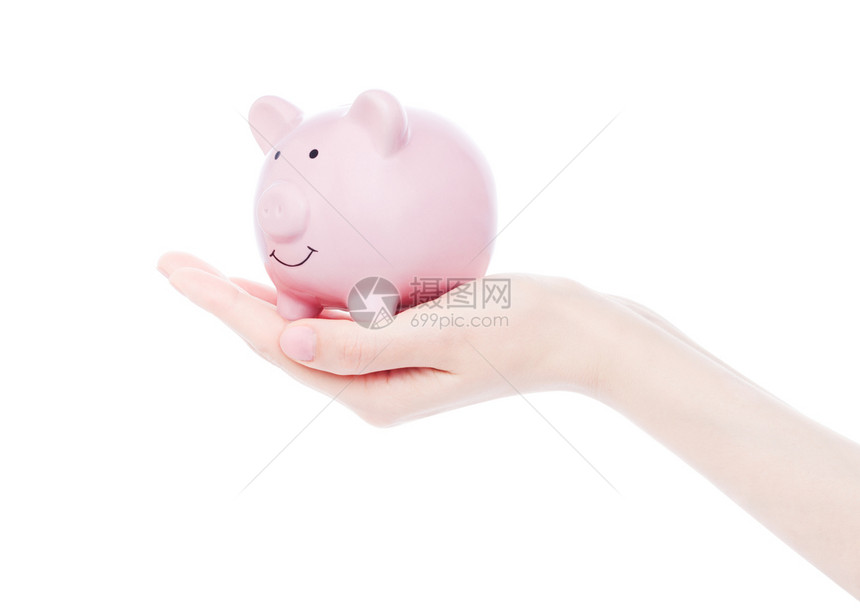 女手握着白色背景的粉红小猪银行图片