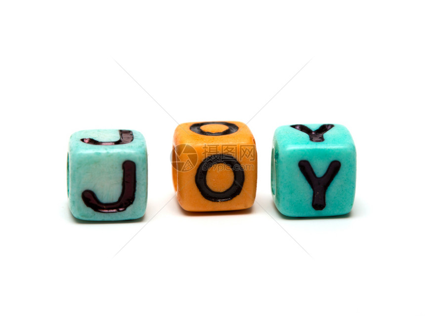 由带字母的多色子玩具立方体创造的喜悦词图片