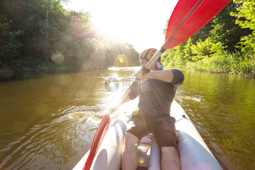 夏季和活跃的体育动日落时一个人在皮艇上打图片