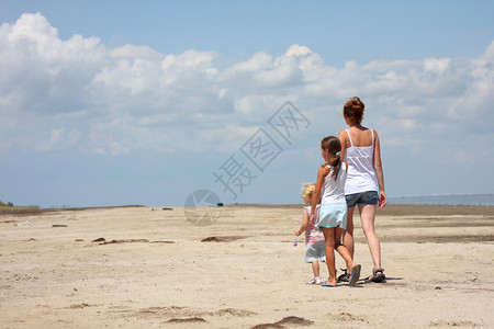 母亲和她的孩子在海滩上图片