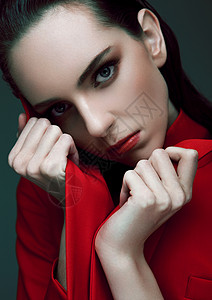 时装模特湿发穿绿色背景的红大衣时装肖像图片