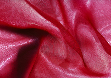 红色丝绸织物上的涟漪特写图片