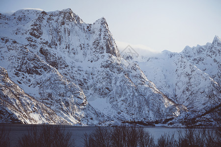 美丽的雪山及其在峡湾的反射图片