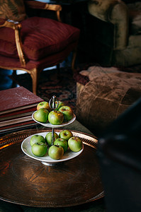 古董黄铜桌上老的客厅陶瓷水果盘中绿苹色图片