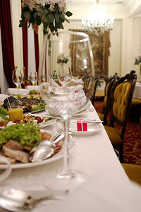 杯子上装着葡萄酒满一半站在假日桌上有选择焦点餐厅有葡萄酒的杯子餐桌图片