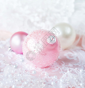 白色和粉颜的美丽圣诞节装饰几个带有白丝和珍珠的圣诞节球在浅薄的彩色背景上带有复制空间的垂直图像背景图片