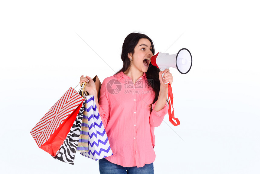 年轻美女拿着购物袋销售概念孤立的白种背景图片