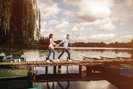 情侣在木桥上牵手约会图片