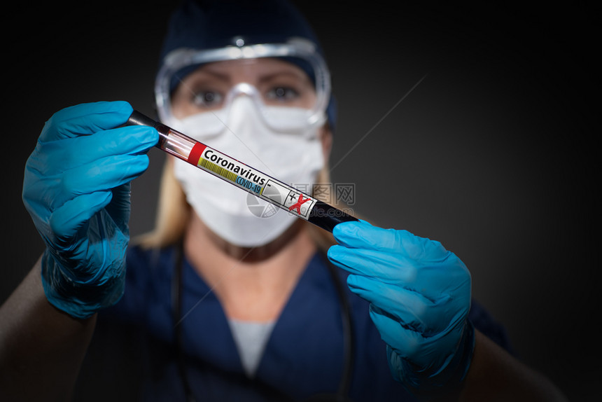 女实验室工人持有标冠状共19种疾病的血液测试管图片