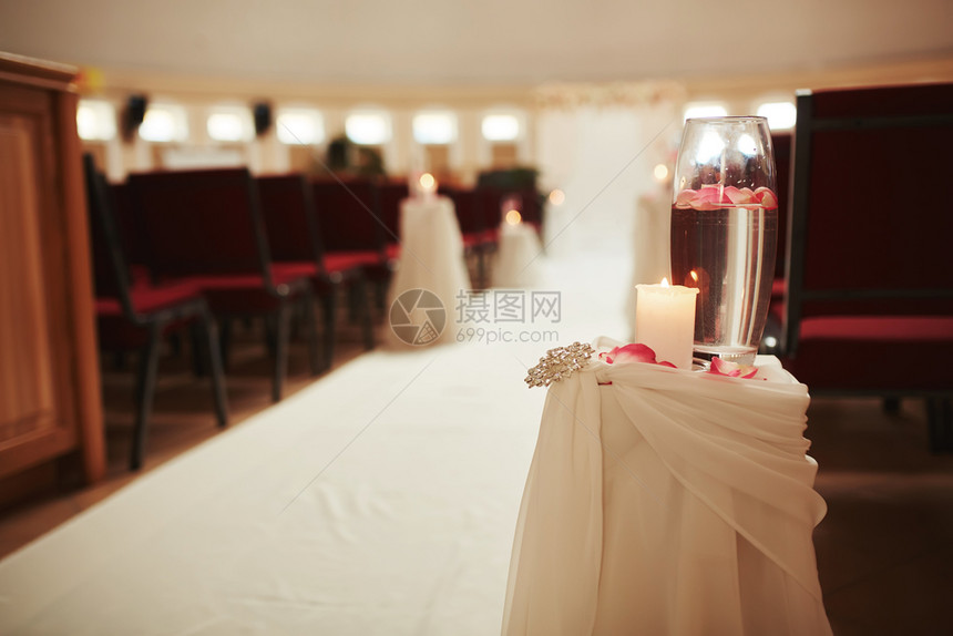 在白桌上装饰一根蜡烛和花瓶白桌上装饰水在婚礼桌上摆放有水和蜡烛的花瓶在婚礼桌上装饰一个蜡烛和花瓶白桌上装饰水图片