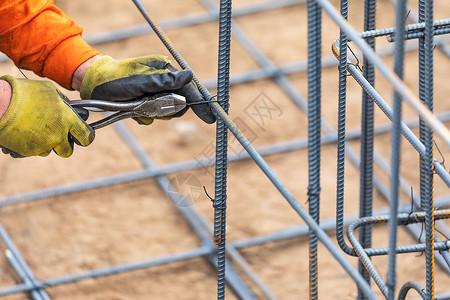 在建筑工地用铁丝钳切割器工具安装钢丝隔板背景图片