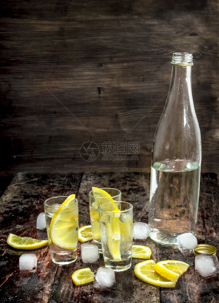伏特加冰和柠檬木制背景图片