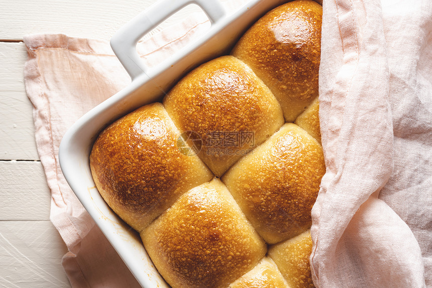 面包在白盘里烤上面盖着粉色毛巾上面有美味的金壳图片