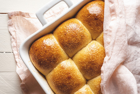 面包在白盘里烤上面盖着粉色毛巾上面有美味的金壳图片