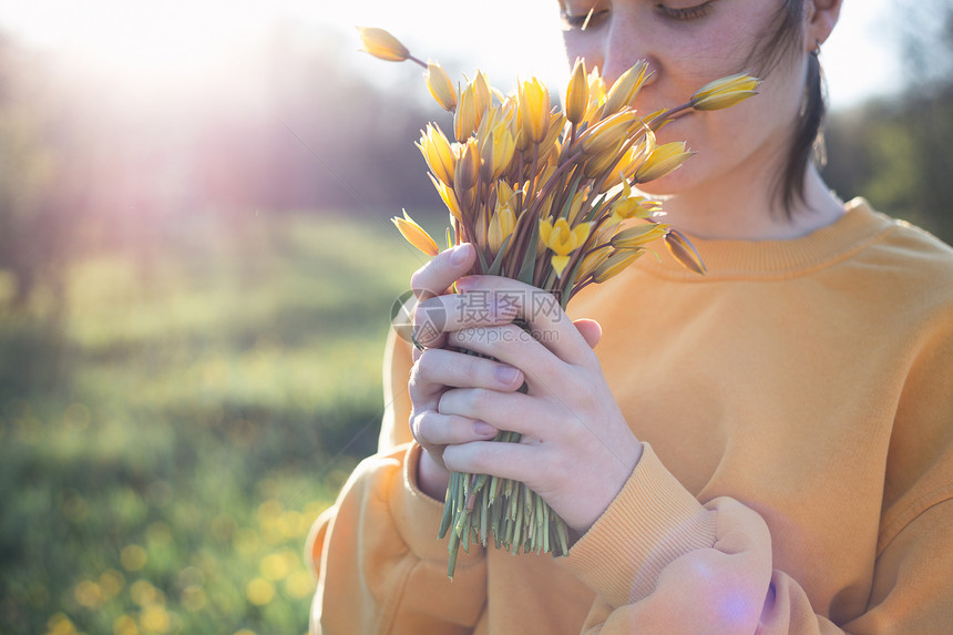 女孩拿着一束黄色野生郁金香花图片