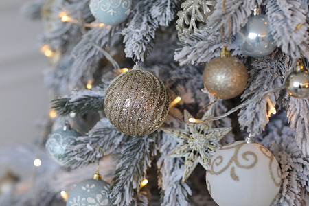 金色的圣诞节背景带有装饰树的点亮灯装饰圣诞树和金色玩具选择焦点图片