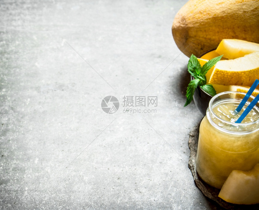 果汁和纸浆甜瓜在石头背景图片