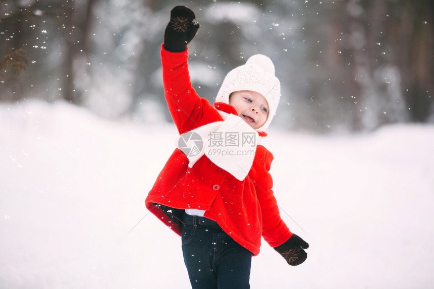 穿着红大衣的小女孩和一只泰迪熊在冬天玩得开心女孩在雪地玩耍女孩在冬天玩得开心图片