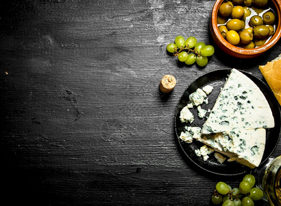 蓝奶酪橄榄和白葡萄黑木本底蓝奶酪橄榄和白葡萄图片