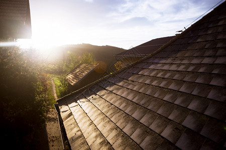 山上村庄的一个农场小街道屋顶和黎明的光线上早有大气图片