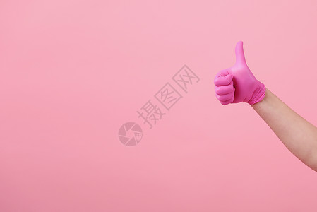 穿粉红乳胶手套的女孩粉红背景保护医学不育穿粉红背景的乳胶手套女孩图片