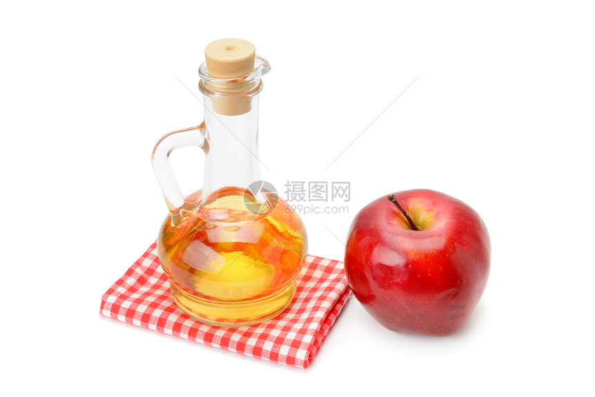 玻璃容器中的苹果醋在白色背景上被隔绝图片
