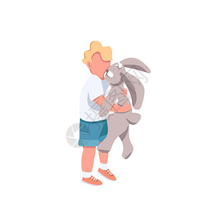 小男孩正在抱着一只兔子玩偶图片