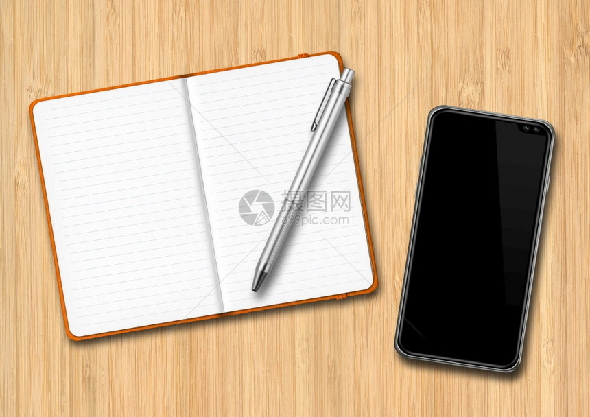 木制桌上的开放笔记本和智能手机笔记本和智能手机放在木制桌上图片