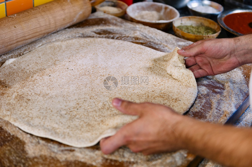 男人用手挣钱做比萨饼披的原料和背景滚动针图片