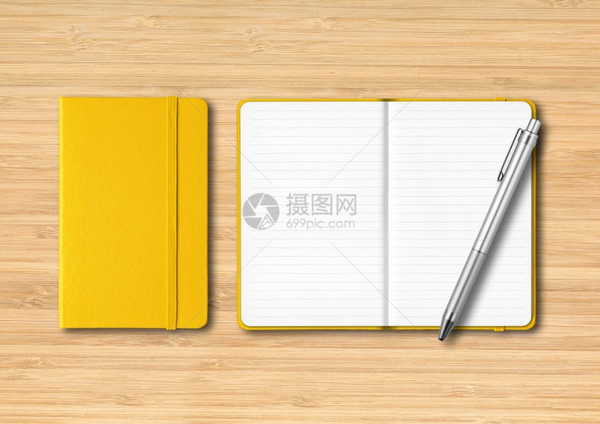 黄闭和开线笔记本有木背景上隔离的模型黄闭和开线笔记本有木背景上的笔图片