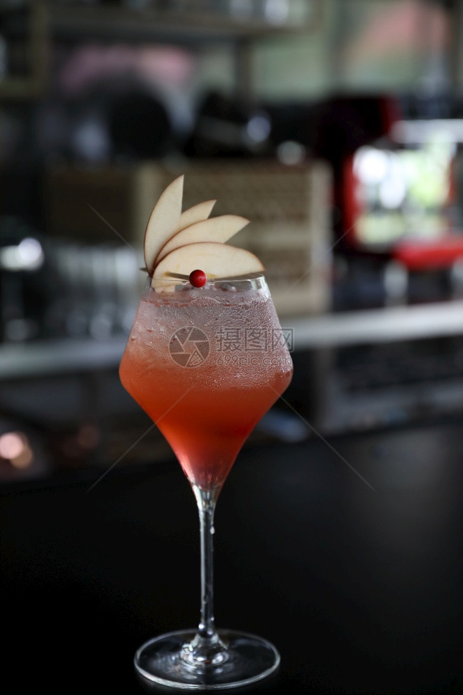 在酒吧柜台加冰的粉红鸡尾酒杯图片