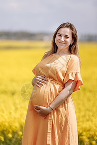 孕妇在油菜花花田里图片