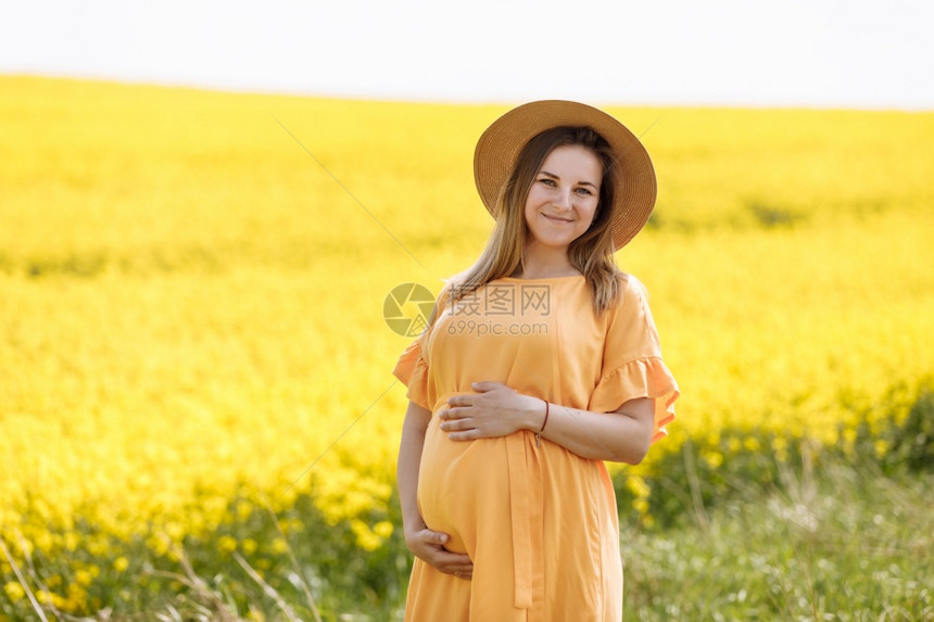孕妇在油菜花花田里图片