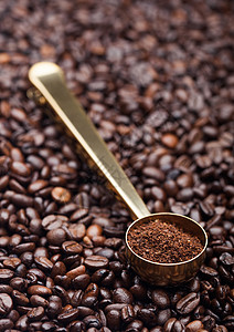 金钢勺中的咖啡粉新鲜豆背景背景图片