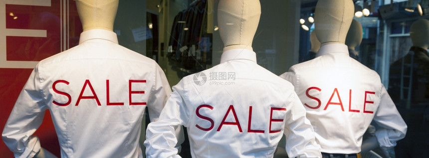 穿牛仔裤的男时装洋娃和以红字母印刷在白衬衫上的销售图片