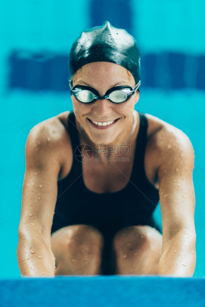 游泳池边缘女运动员肖像图片
