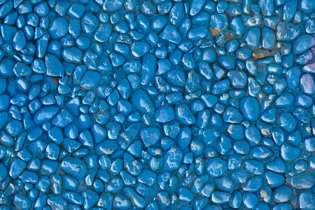 蓝色墙由小石头制成背景图片
