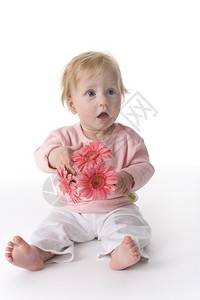 女婴与粉红花坐在地板上背景图片