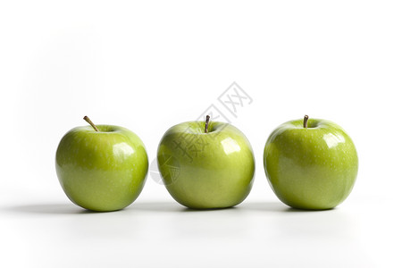 连续三个绿色闪亮的奶史密斯苹果背景图片