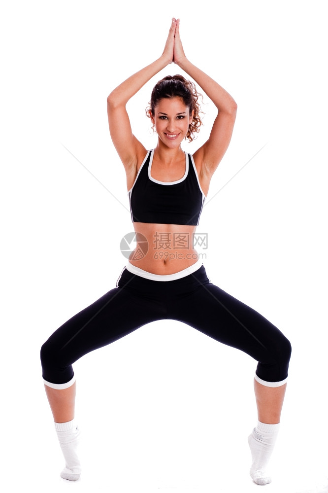 参加瑜伽的合适女在白色背景上摆姿势图片