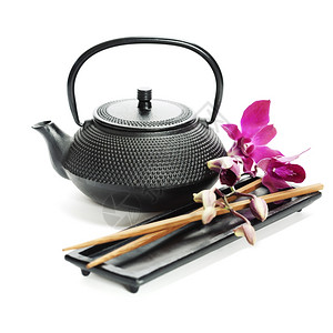 亚洲食品概念茶锅兰花和筷子图片