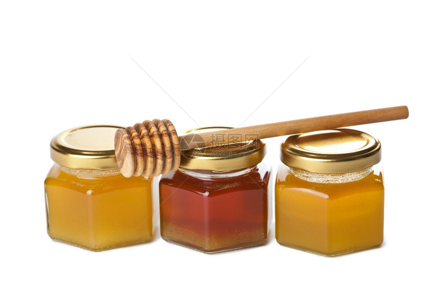 瓶装蜂蜜和木制花瓶中的蜂蜜与世隔绝图片