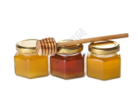 瓶装蜂蜜和木制花瓶中的蜂蜜与世隔绝图片