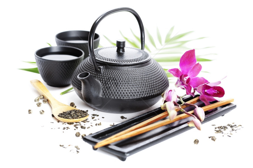 亚洲粮食概念绿色茶叶兰花和筷子图片