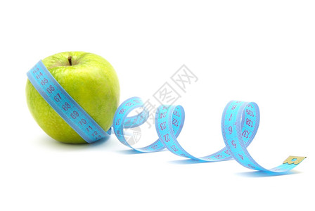 绿色苹果和白测量胶带背景图片
