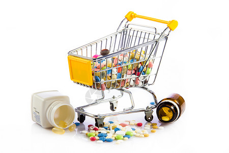 购物车与药物手推车上的彩色药片白背景的药片和丸购物车背景