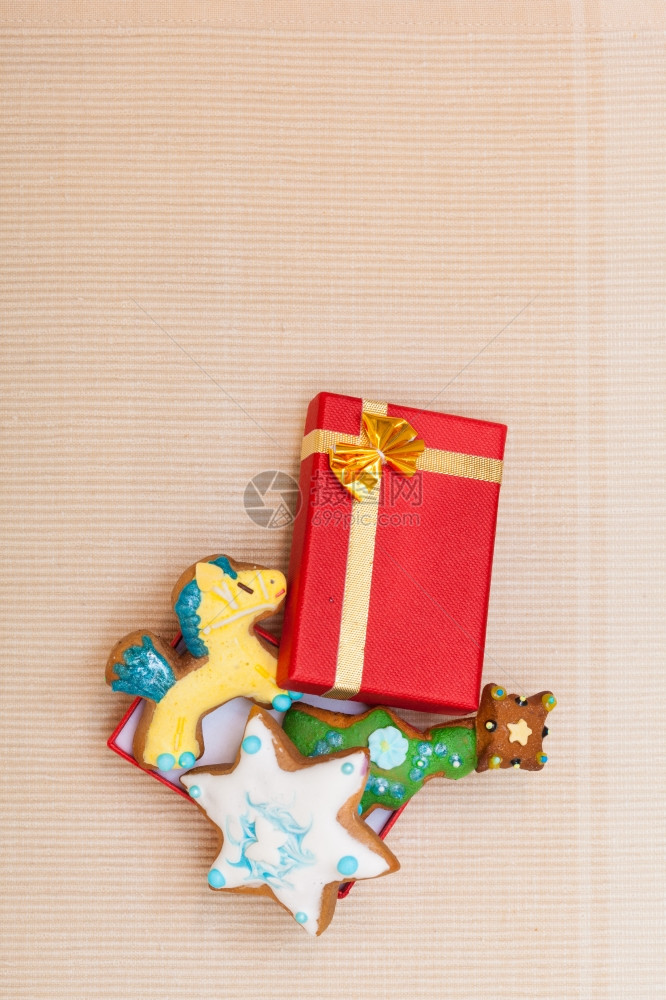 圣诞手工做的姜饼蛋糕有冰淇淋和装饰甜红礼盒有棕色背景的金丝带假日概念图片
