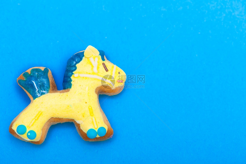 自制的姜饼小马有冰淇淋和蓝色黄装饰品圣诞节日手工制作的概念图片